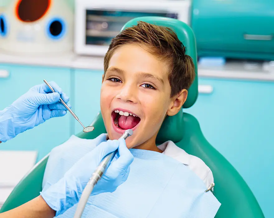 Child sitting in chair at the dentist