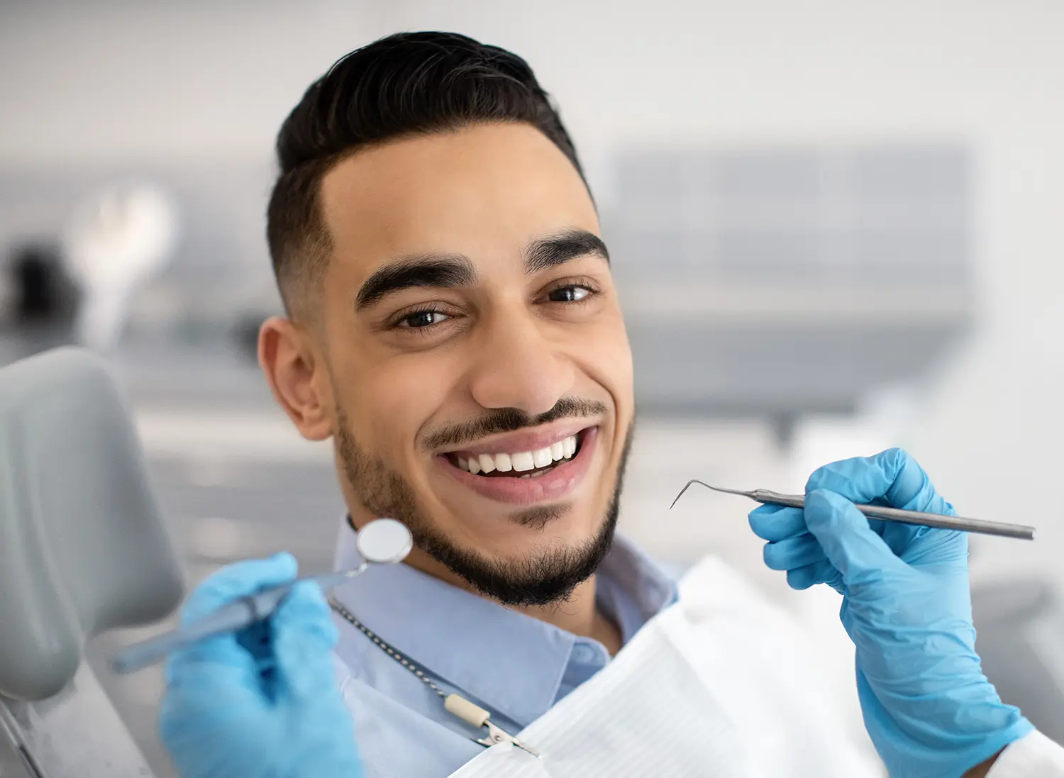 Young man sitting in dental chair smiling