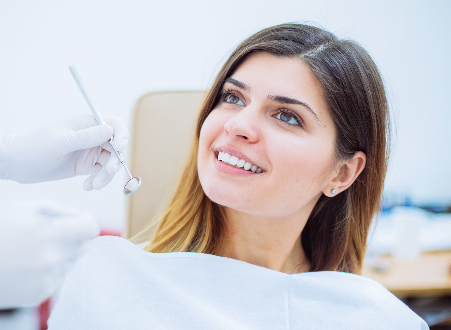 Young woman smiling in dentist chair